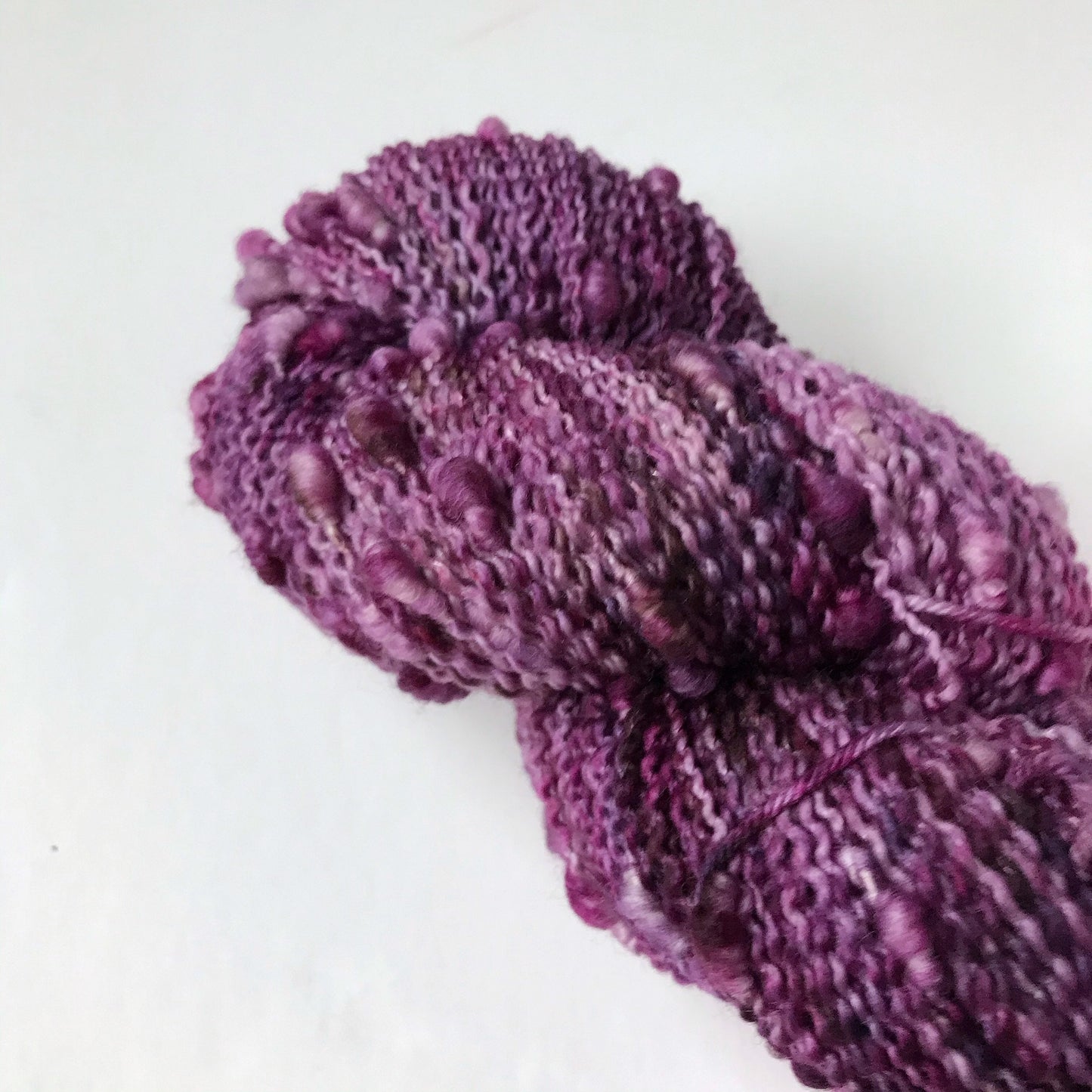 textured purple, burgundy and black fingering weight yarn