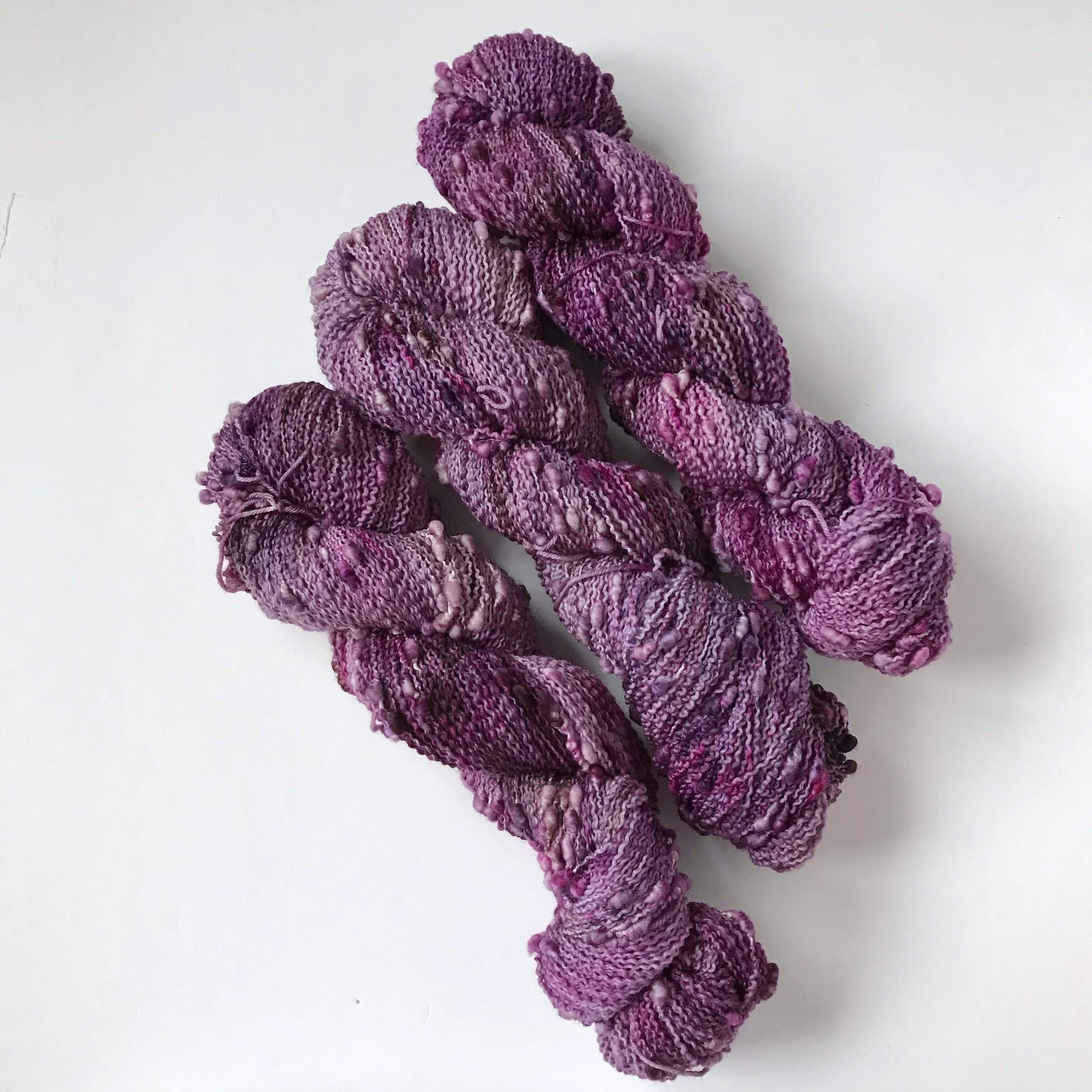 textured purple, burgundy and black fingering weight yarn