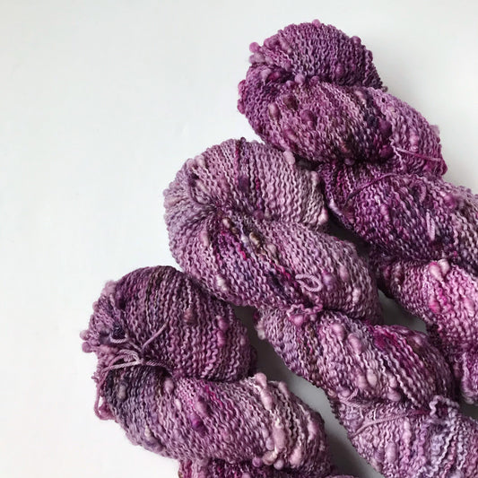 textured purple, burgundy and black fingering weight yarn